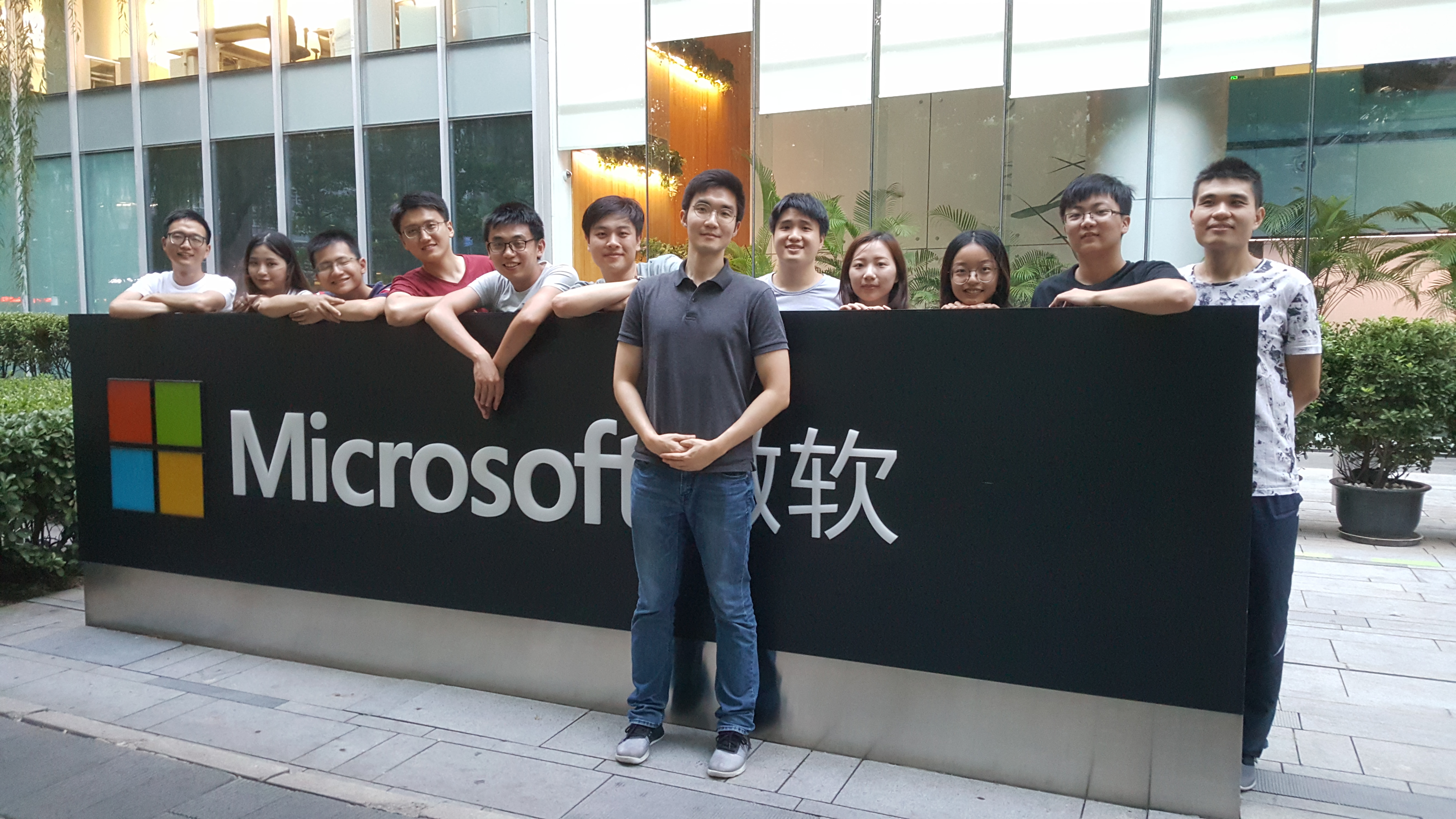 Above: MSRA dining group taking a photo in front of the Microsoft logo under Building 2