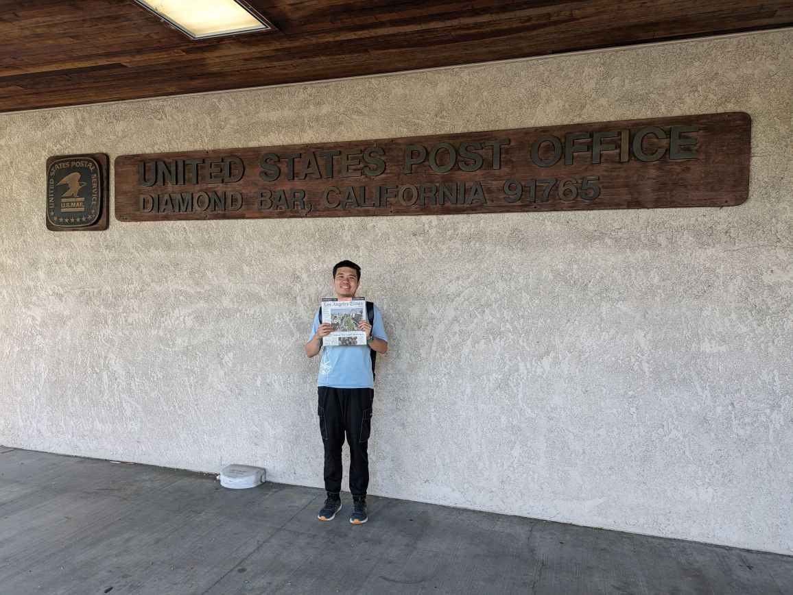 Take a photo with the newspaper in front of the landmark