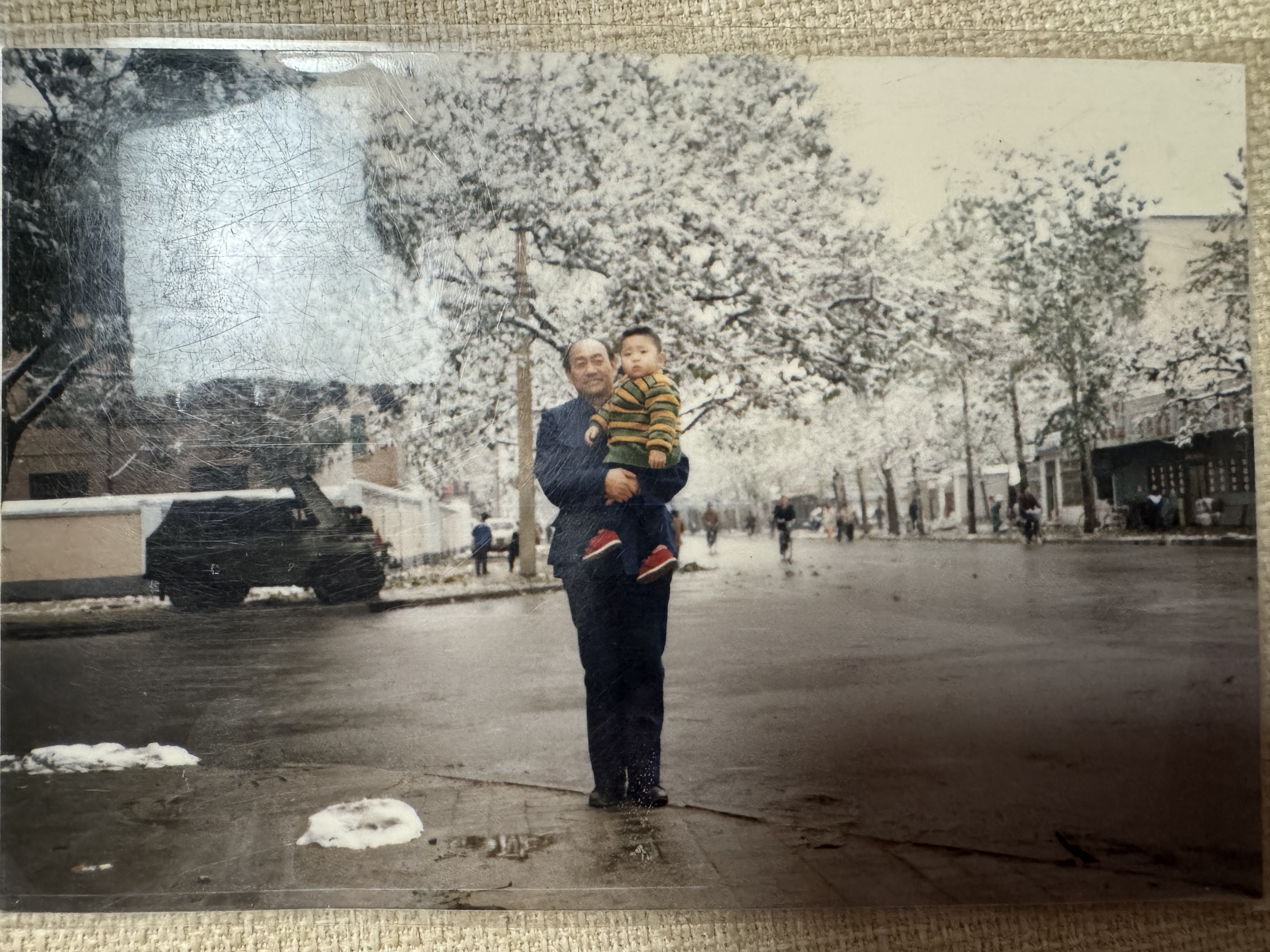 My grandfather holding me on the street to recognize characters