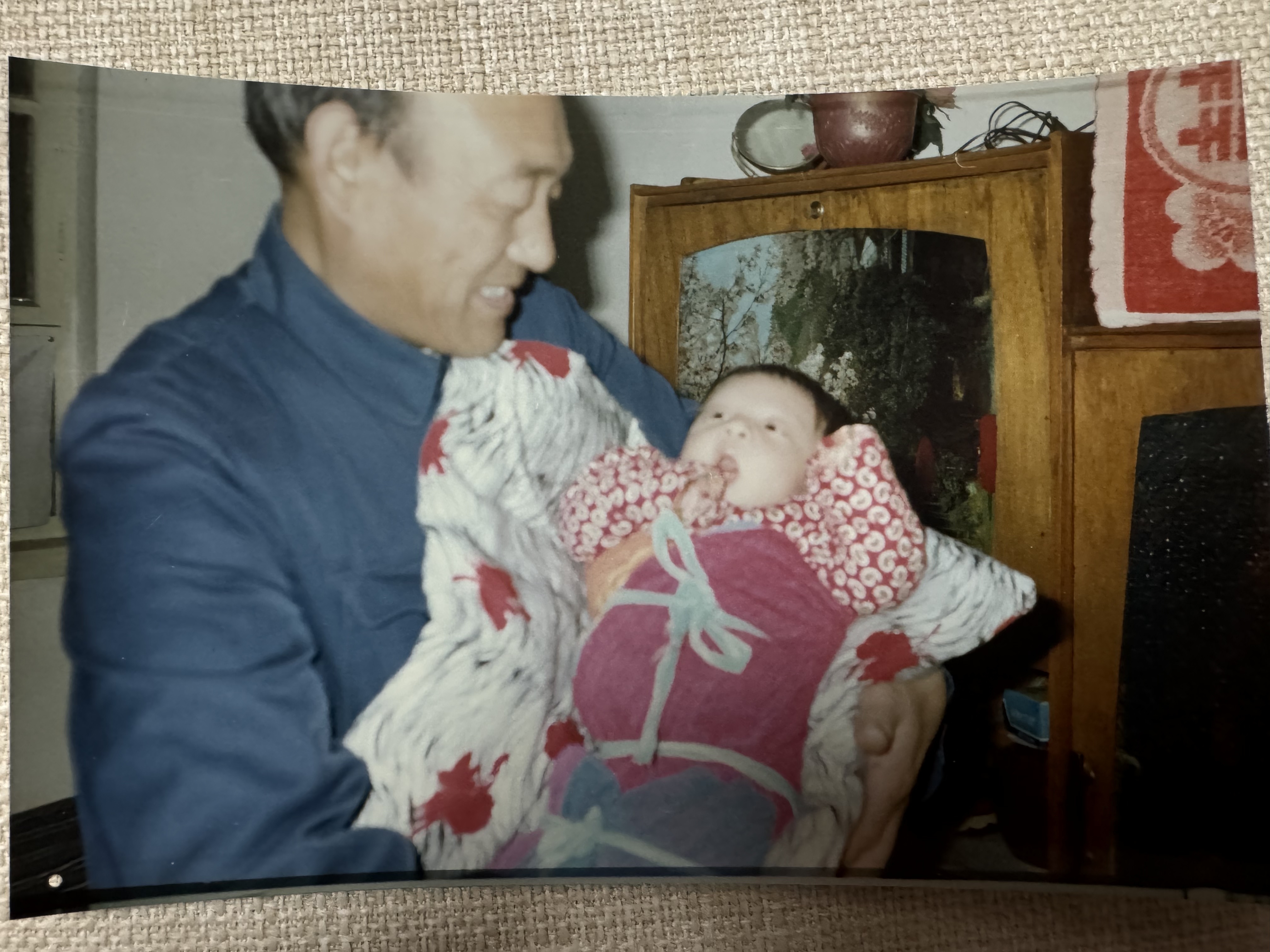 My grandfather holding me when I was young